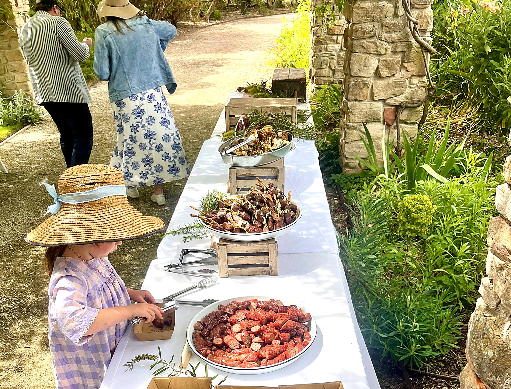 Sun Bear BBQ catering spread laid out at a garden event